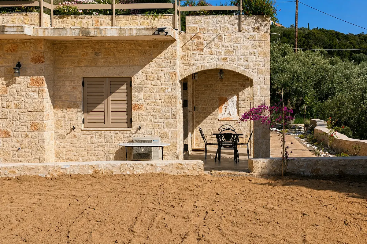 Achilles Cottage stone exterior with garden in Kardamyli Mani Peninsula