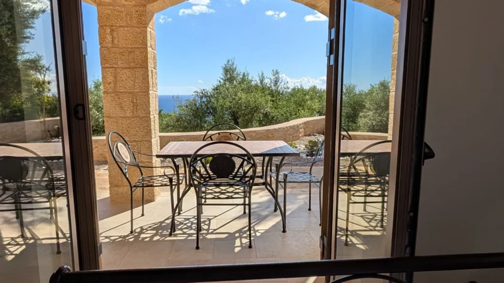 Achilles Cottage terrace with sea view and French doors in Kardamyli
