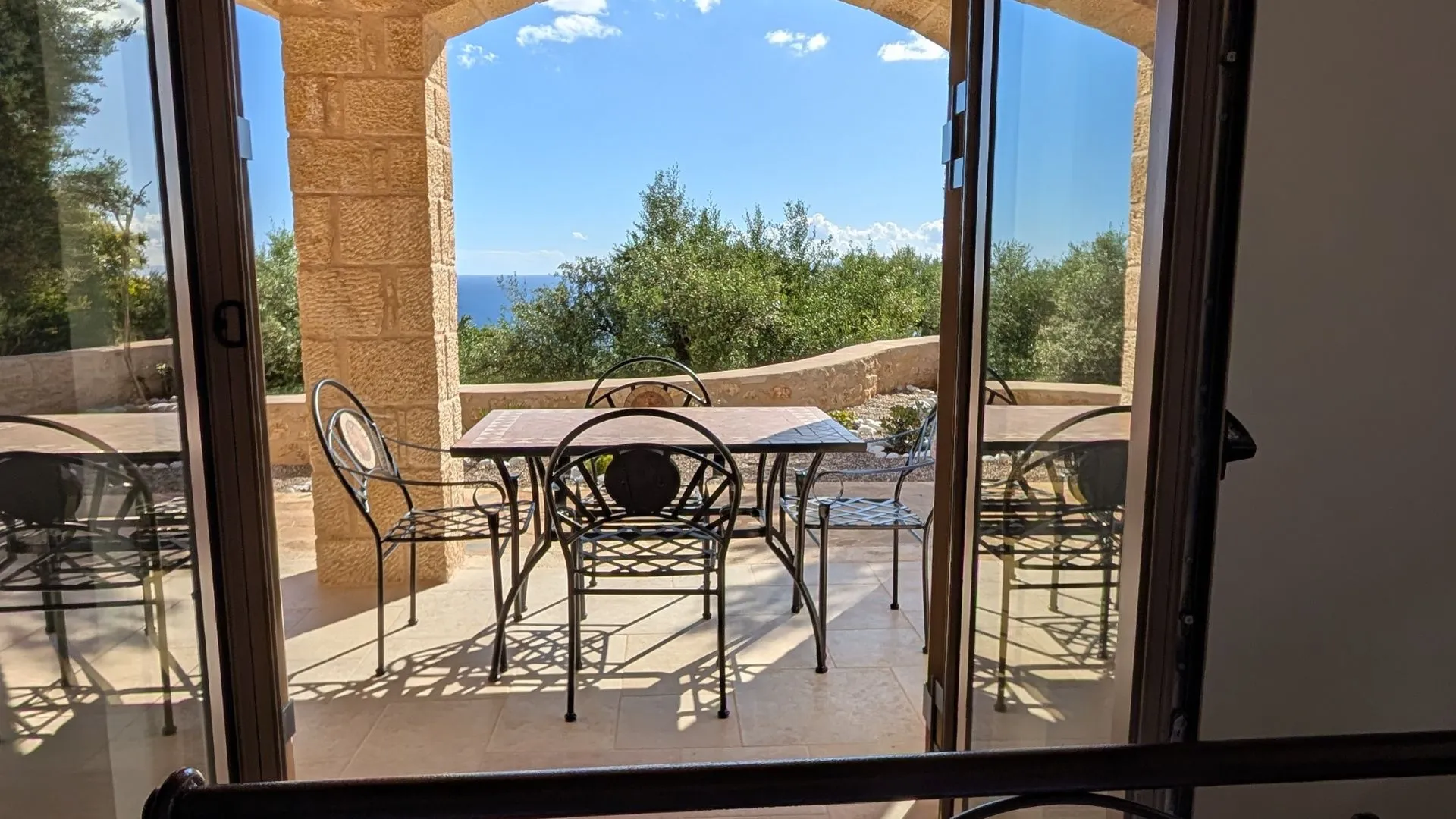 Achilles Cottage terrace with sea view and French doors in Kardamyli